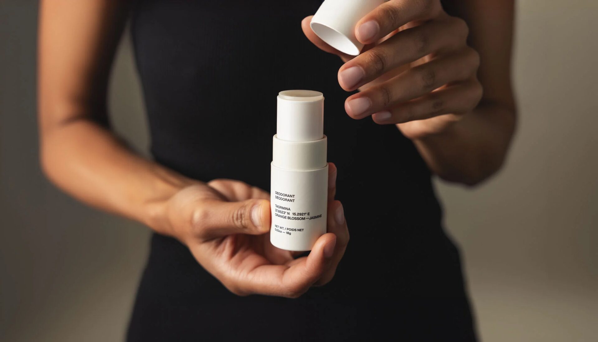 Model holding Evolve Together deodorant in hands