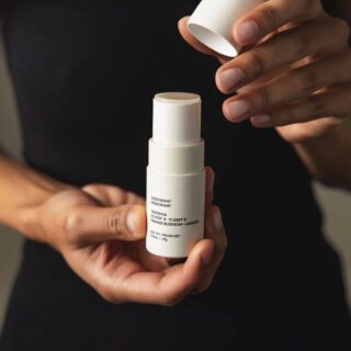 Model holding Evolve Together deodorant in hands