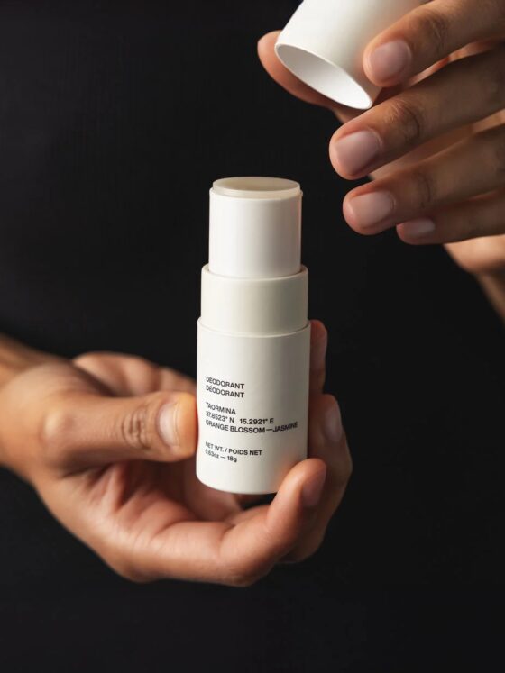 Model holding Evolve Together deodorant in hands