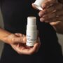 Model holding Evolve Together deodorant in hands