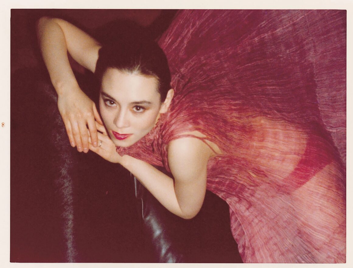 Photo of China Chow wearing a red sheer cover