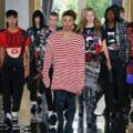 Oliver Rousteing wearing a red and white strip sweater surrounded by male and female models from Balmain Spring 2019 show